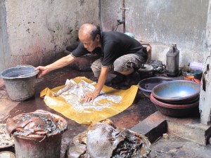 Aprat preparing Tatang's batik for Napthol dyeing.