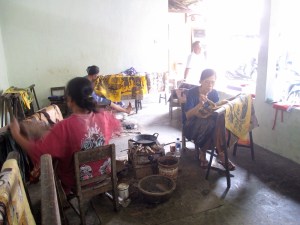 Women working on different stages of the batik.