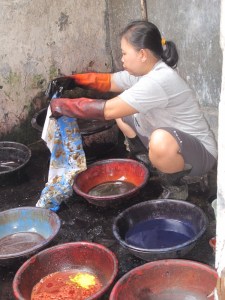 One of Aprat's  friends and assistant dyeing his work.