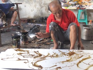 Aprat Koeswadji working on silk, using a mixture of beeswax and tree resin,