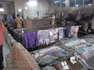 Dye room with workers rinsing the completed batik