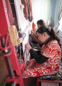 Women working on a traditional design on silk carpet made with naturally dyed silk threads.