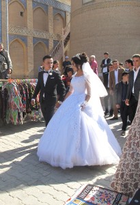 A modern wedding, couple at Islam-Khadja Madrasah, Khiva, Uzbekistan.